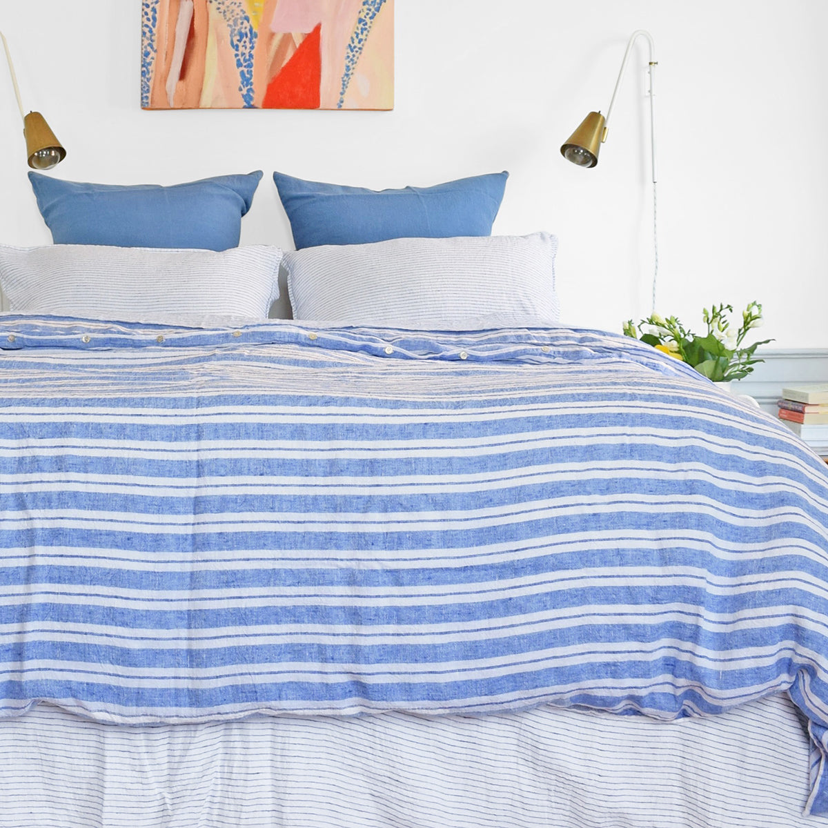 A Linge Particulier Linen Duvet in Large Blue Stripes gives a blue and white stripe color to this duvet for a colorful patterned and printed linen bedding look from Collyer's Mansion