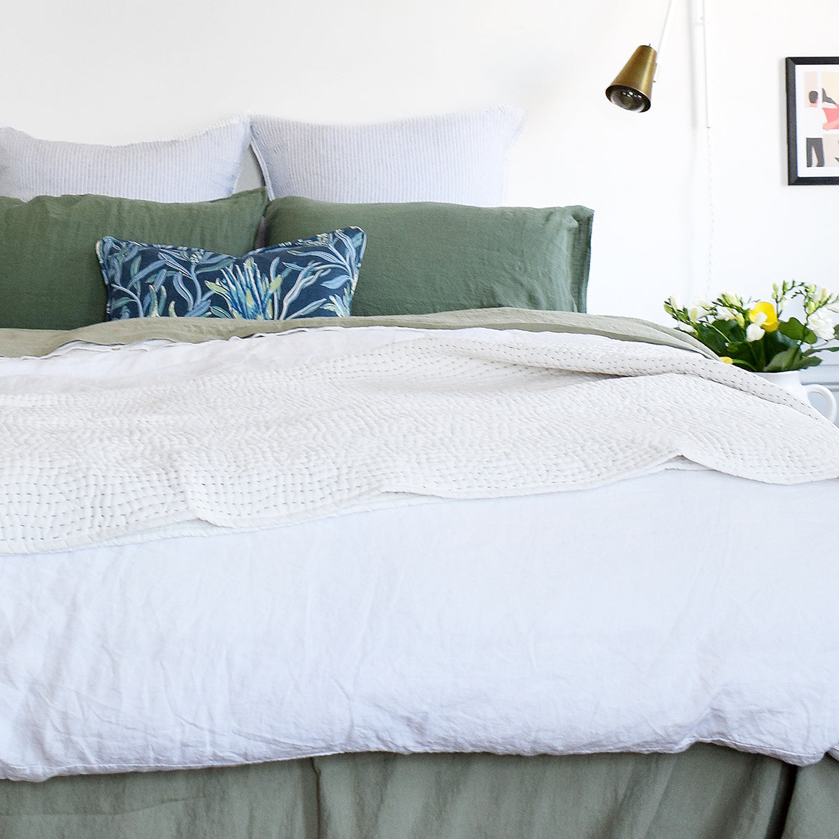 Linge Particulier Jade Green Standard Linen Pillowcase Sham with a white linen duvet and blue Utopia Goods pillow for a colorful linen bedding look in camo green - Collyer&#39;s Mansion