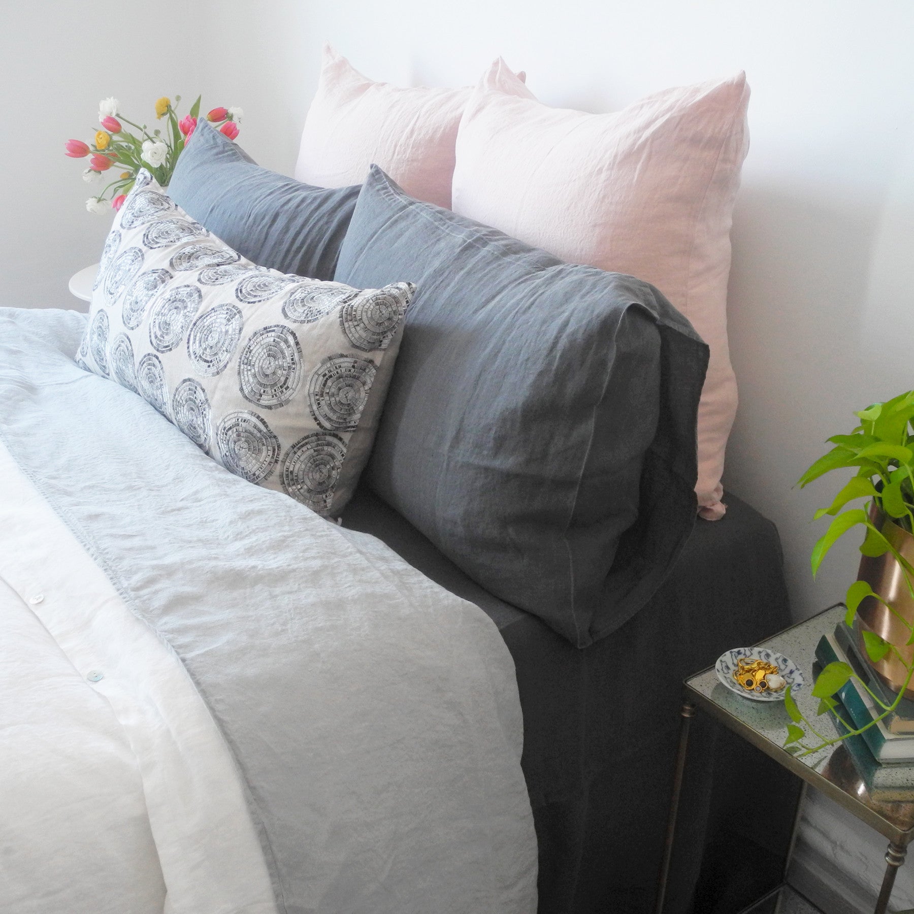 Linge Particulier Nude Euro Linen Pillowcase Sham with grey linen sheet and charcoal grey linen pillowcases with a Coral & Tusk pillow for a colorful linen bedding look in soft blush pink - Collyer's Mansion