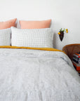 Linge Particulier Navy Check Standard Linen Pillowcase Sham with a stripe linen duvet and copper euro shams for a colorful linen bedding look in blue check - Collyer's Mansion