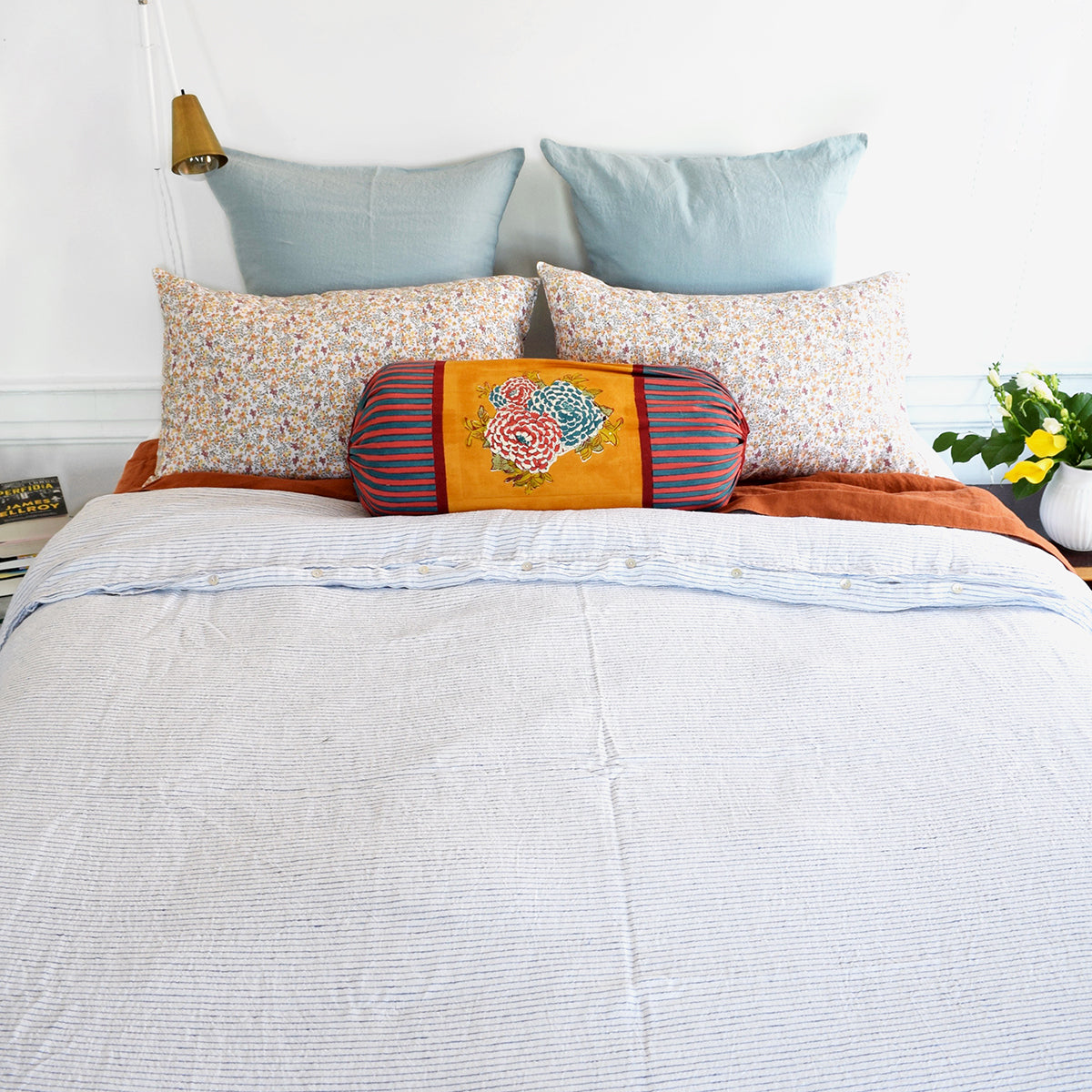 A Linge Particulier Linen Duvet in Atlantic Blue Stripe gives a white and blue pinstripe color to this duvet for a sky blue patterned and printed linen bedding look from Collyer's Mansion