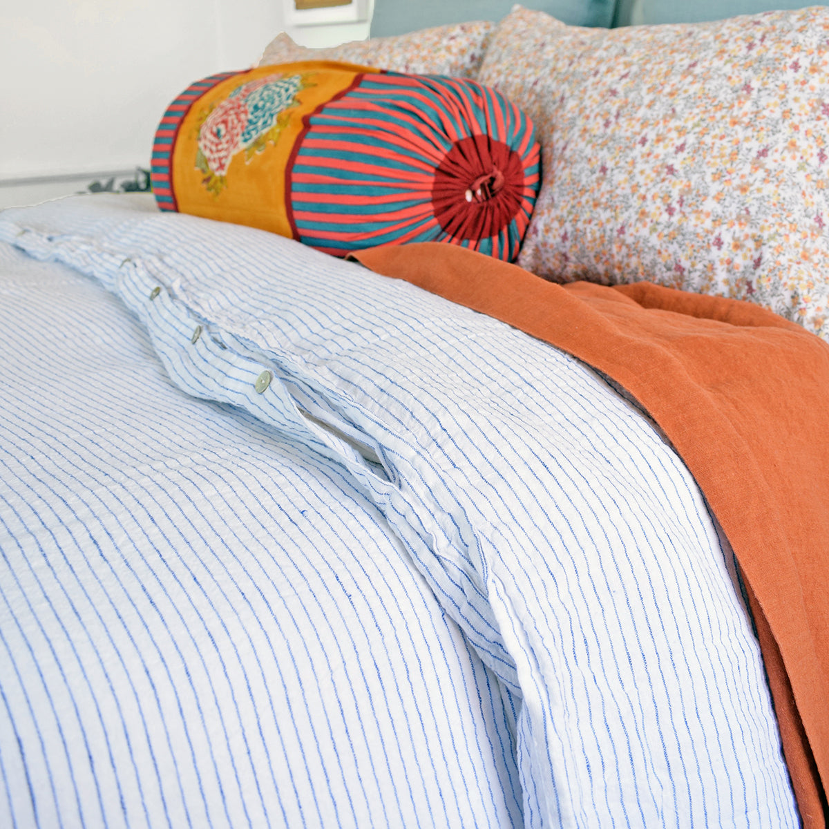 A Linge Particulier Linen Duvet in Atlantic Blue Stripe gives a white and blue pinstripe color to this duvet for a sky blue patterned and printed linen bedding look from Collyer's Mansion