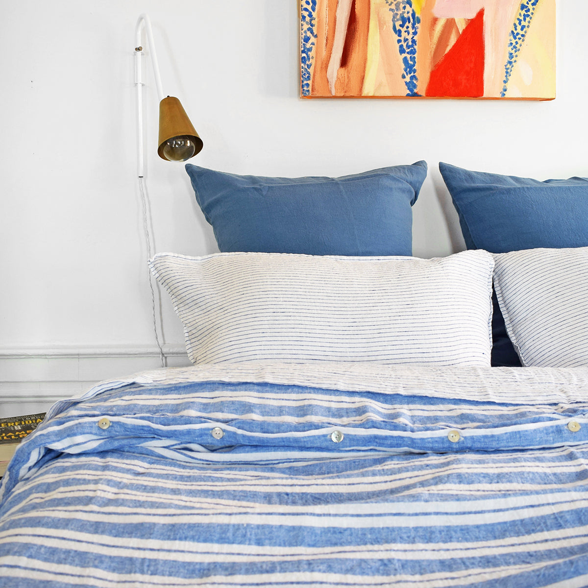 A Linge Particulier Linen Duvet in Large Blue Stripes gives a blue and white stripe color to this duvet for a colorful patterned and printed linen bedding look from Collyer&#39;s Mansion