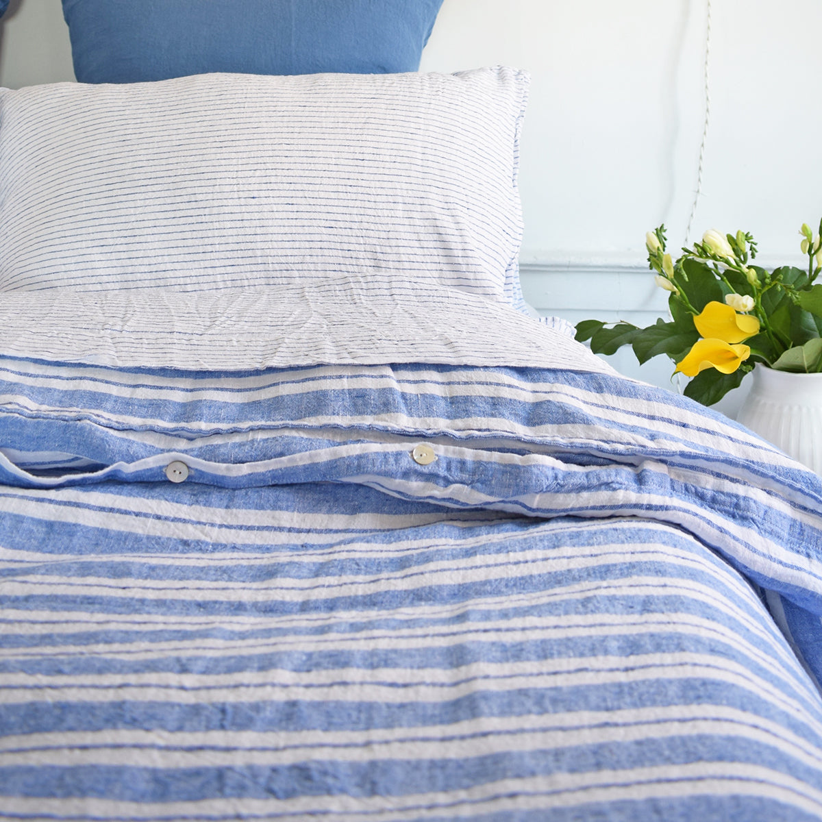A Linge Particulier Linen Duvet in Large Blue Stripes gives a blue and white stripe color to this duvet for a colorful patterned and printed linen bedding look from Collyer's Mansion