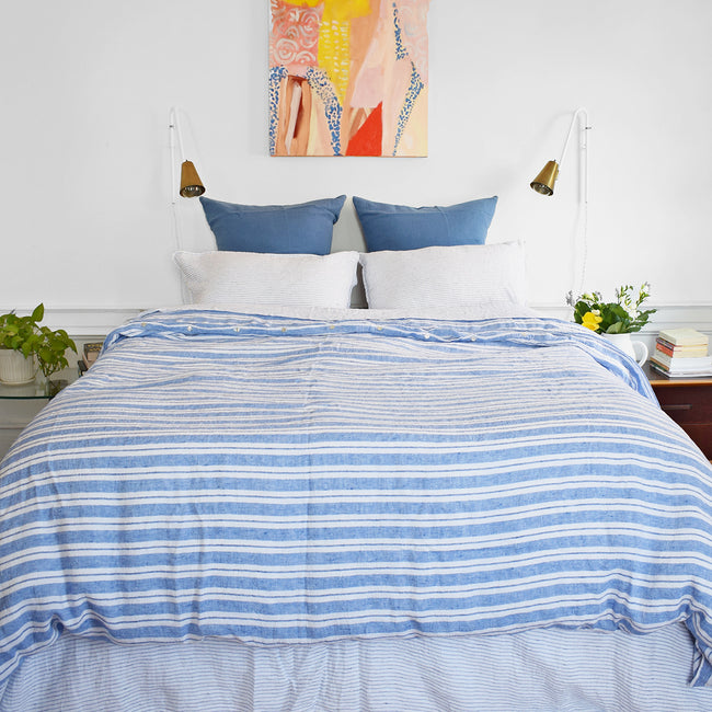 A Linge Particulier Linen Duvet in Large Blue Stripes gives a blue and white stripe color to this duvet for a colorful patterned and printed linen bedding look from Collyer's Mansion