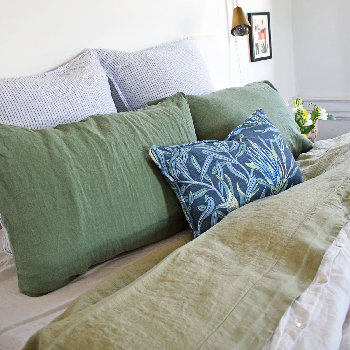 Linge Particulier Jade Green Standard Linen Pillowcase Sham with a fennel green linen sheet and blue Utopia Goods pillow for a colorful linen bedding look in camo green - Collyer&#39;s Mansion