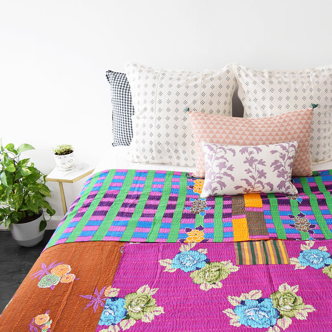 Colorful lilac vine pillow mixed with other pillows for colorful home decor and a vibrant bedding look - Collyer's Mansion