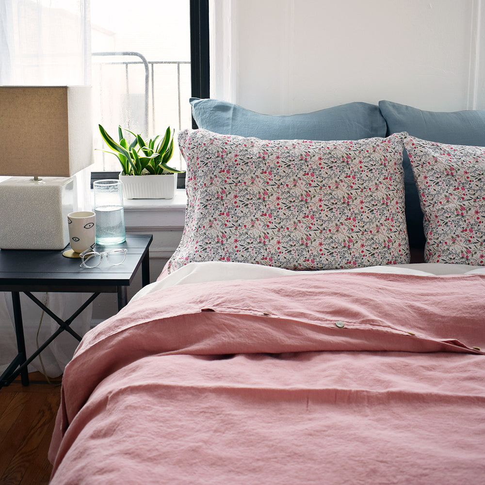 Linge Particulier Scandinavian Blue Euro Linen Pillowcase Sham with a pink linen duvet and small floral pattern linen pillowcases for a colorful linen bedding look in grey blue - Collyer's Mansion
