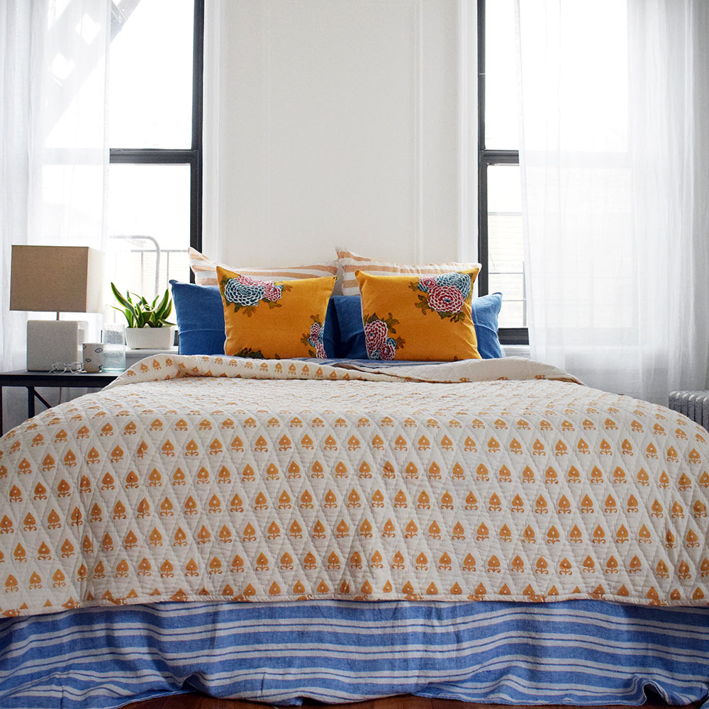 Block printed quilt in mustard yellow handmade by Serendipity Delhi for colorful bedding at Collyer's Mansion