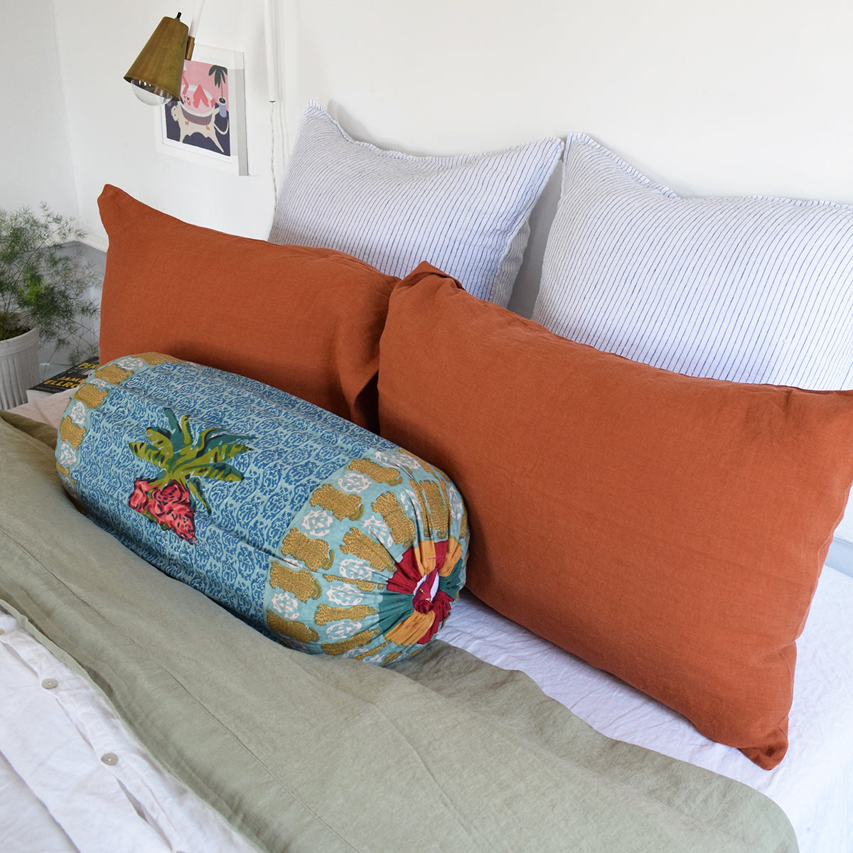 Linge Particulier Sienna Orange Standard Linen Pillowcase Sham with Lisa Corti bolster pillow and blue stripe euro shams for a colorful linen bedding look in burnt orange - Collyer&#39;s Mansion
