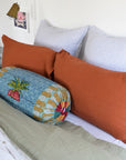 Linge Particulier Sienna Orange Standard Linen Pillowcase Sham with Lisa Corti bolster pillow and blue stripe euro shams for a colorful linen bedding look in burnt orange - Collyer's Mansion