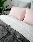 Linge Particulier Cloud Grey Euro Linen Pillowcase Sham with a charcoal linen duvet and nude pink pillowcases for a colorful linen bedding look in light grey - Collyer's Mansion